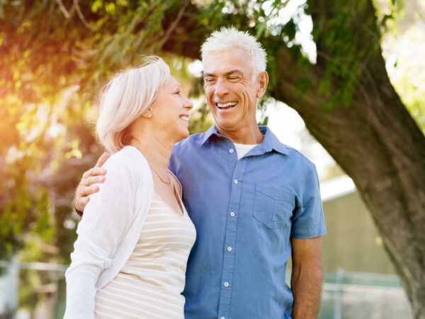 Happy older couple embracing outside