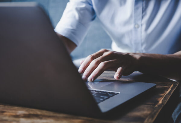 Man typing on a laptop